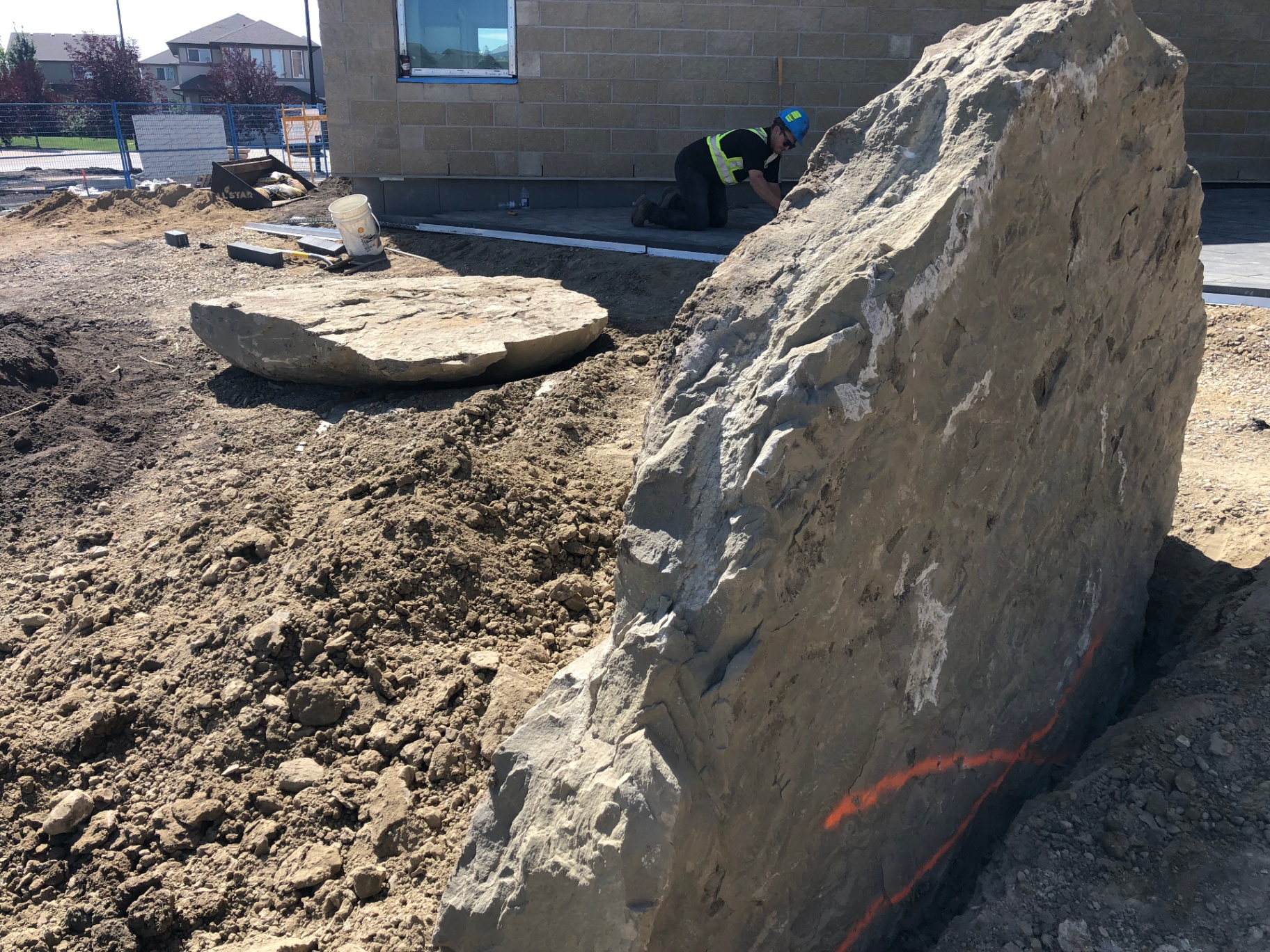 All Star crew placing a large feature boulder at a commercial site