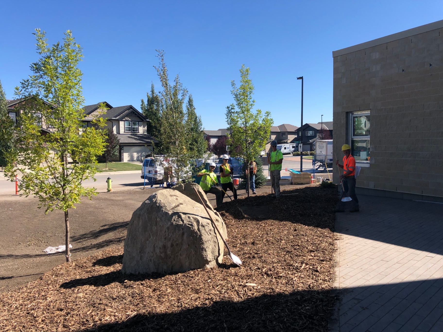 Finishing landscape work along a new commercial building