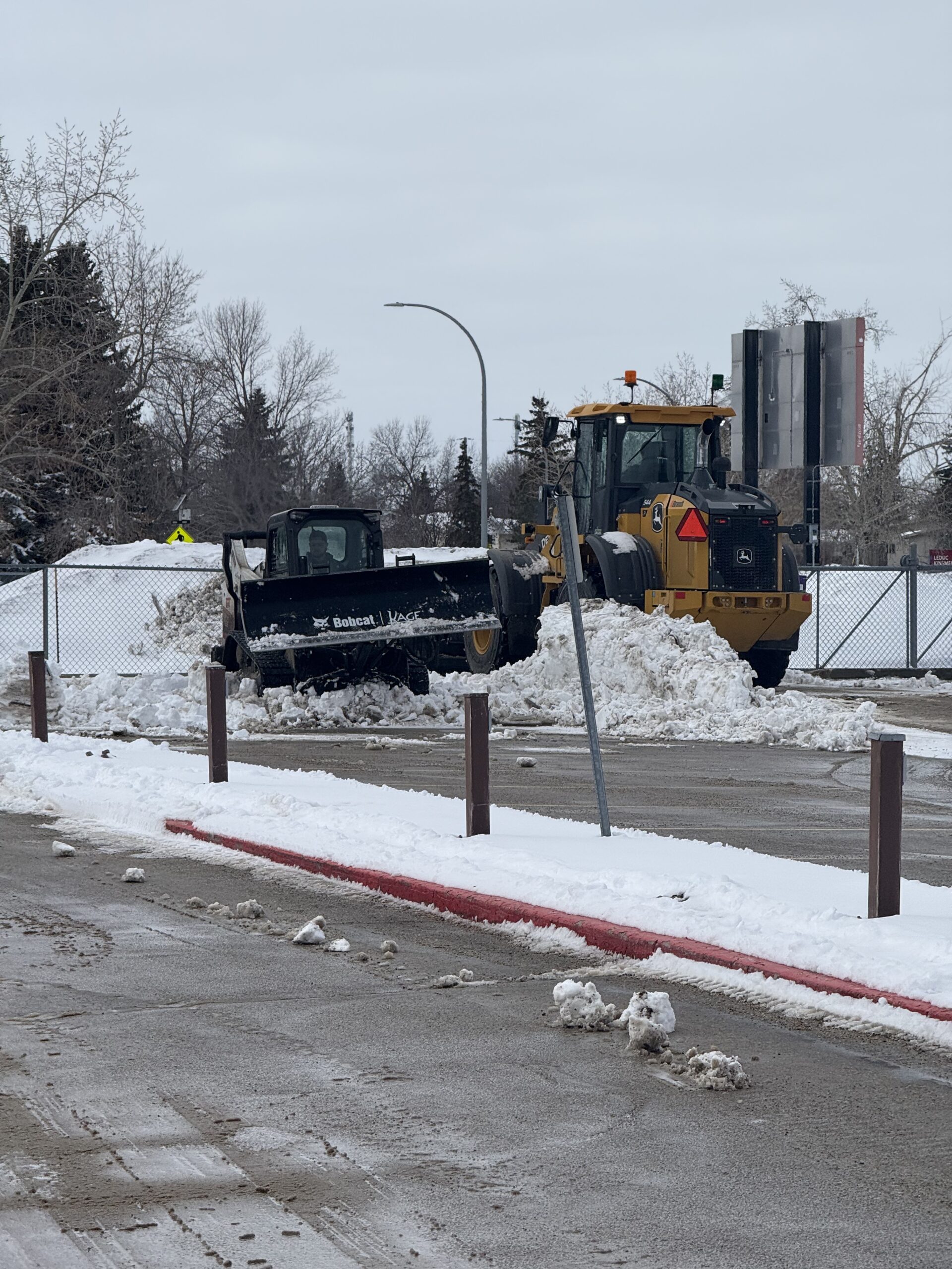 Cleared sidewalks and curb line after plowing