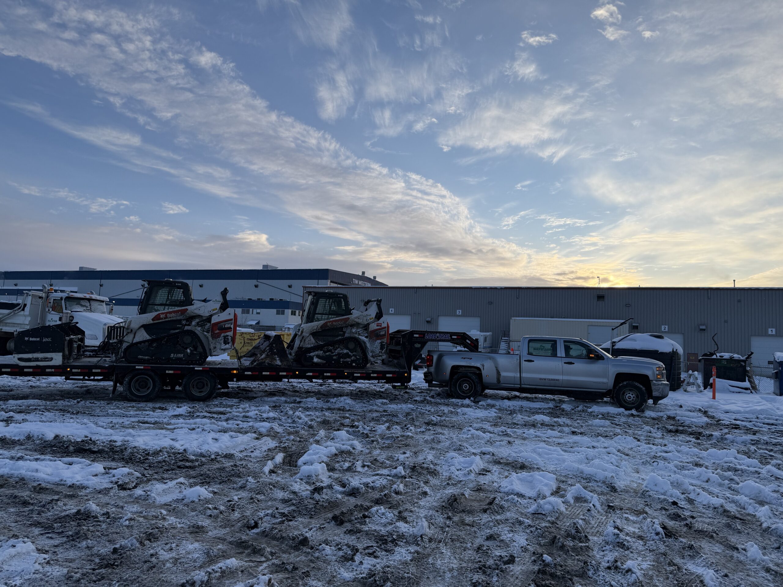 Snow equipment staged at the yard at sunrise