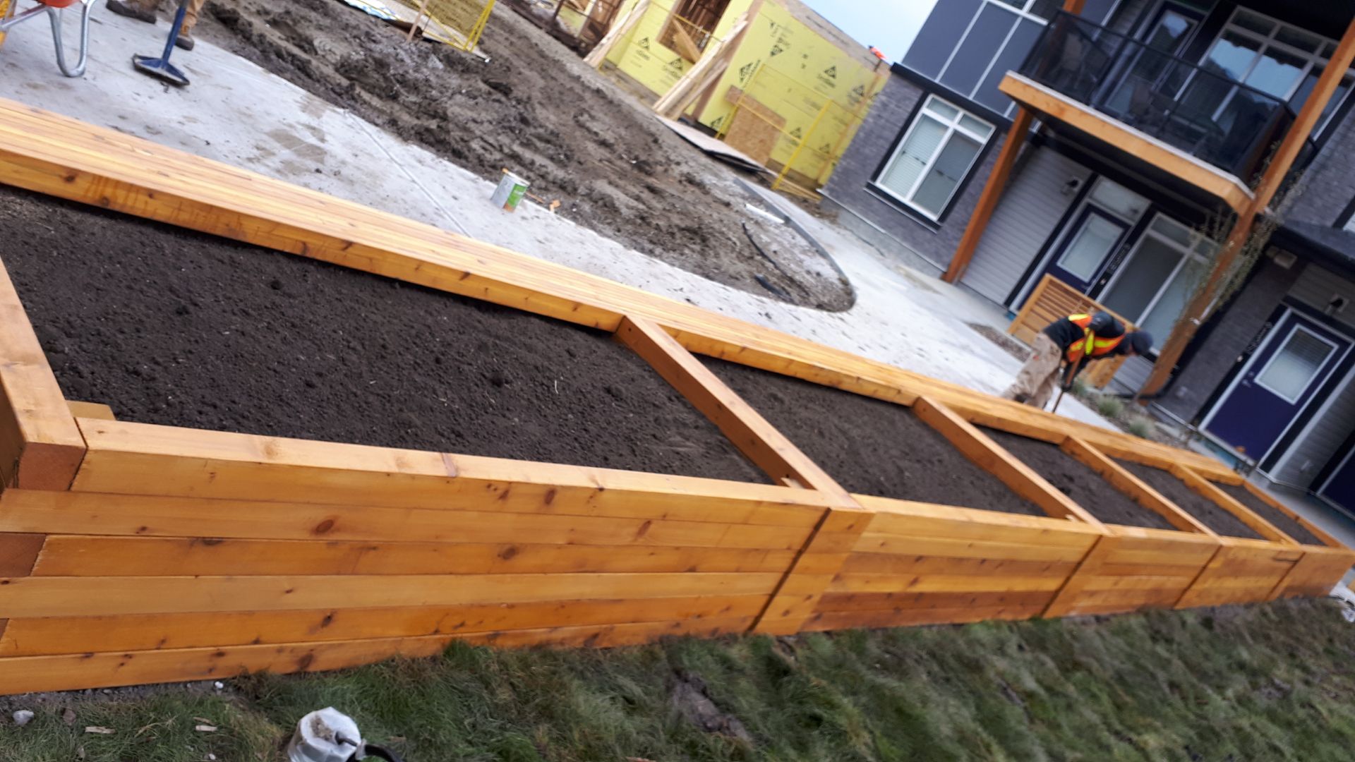 Cedar raised planter under construction on a commercial site