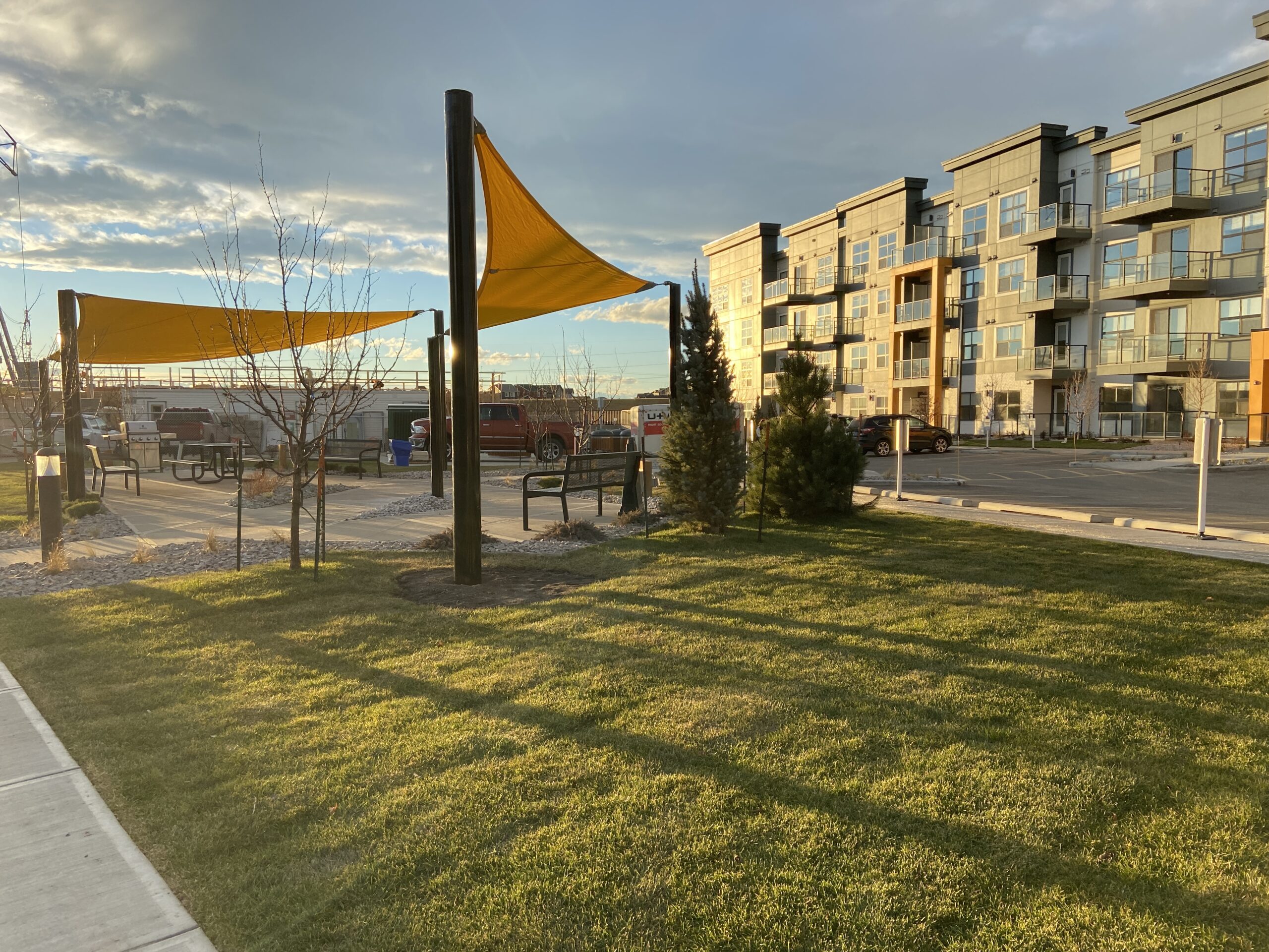 Shade sail and lawn in the courtyard of a multi-family development